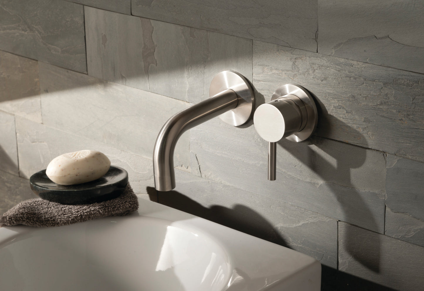 JTP Inox wall-mounted basin mixer tap with single lever, modern design, installed on bathroom sink for easy water control