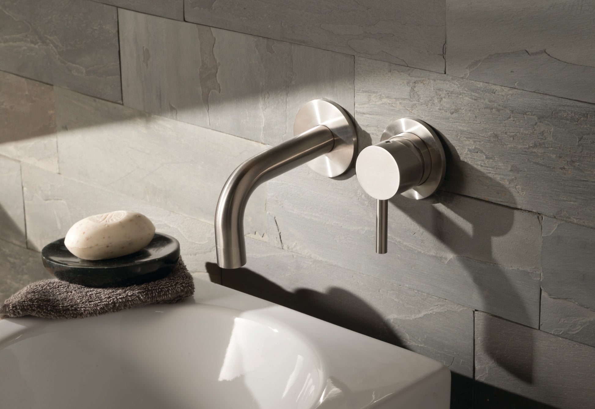 JTP Inox wall-mounted basin mixer tap with single lever, modern design, installed on bathroom sink for easy water control