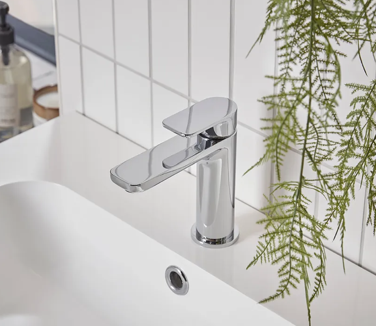 Tavistock Savour basin mixer tap with click waste, modern chrome finish, shown installed on a bathroom sink.