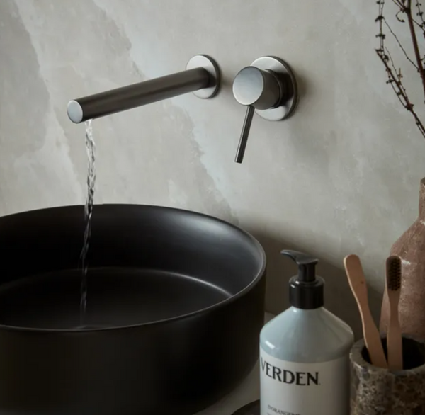 Tavistock Anthem wall-mounted basin mixer tap with modern design and sleek chrome finish, shown installed on a bathroom sink.